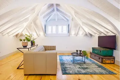 a living room with a couch and a tv at Mouzinho 202 in Porto
