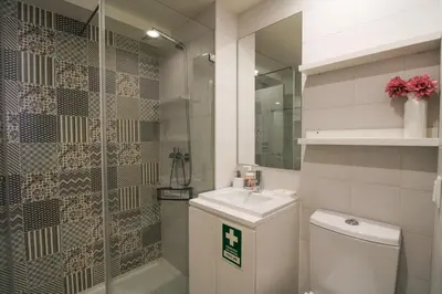 a bathroom with a toilet and a sink and a shower at Mouzinho Mezzanine in Porto