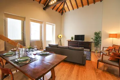 a living room with a table and a couch at Mouzinho Mezzanine in Porto
