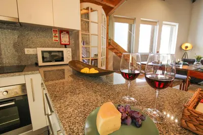 two glasses of wine and cheese on a kitchen counter at Mouzinho Mezzanine in Porto