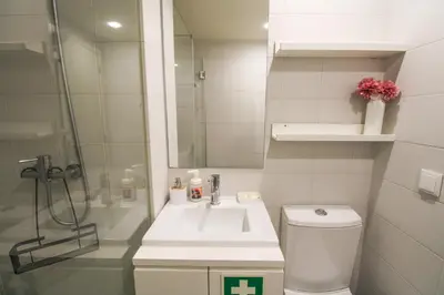 a bathroom with a sink and a shower and a toilet at Mouzinho Mezzanine in Porto