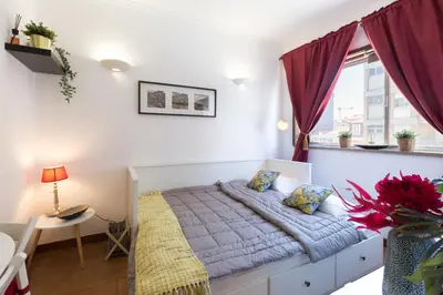 a small bedroom with a bed and a window at Host Wise - Cool Flat - City Center near Aliados in Porto