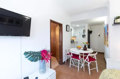 a kitchen and a living room with a table and chairs at Host Wise - Cool Flat - City Center near Aliados in Porto