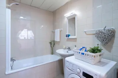 a bathroom with a tub and a sink and a toilet at Host Wise - Cool Flat - City Center near Aliados in Porto