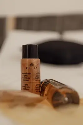 a bottle of moisturizing glue sitting next to a bottle at Coruja’s House AL OPO in Porto