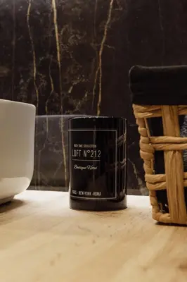 a black candle sitting on a wooden table at Coruja’s House AL OPO in Porto