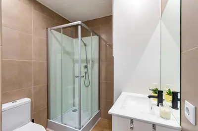 a bathroom with a shower and a toilet and a sink at Lusi'Apartment - Douro River so close by Guest SPA in Porto