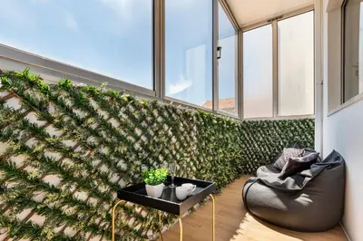 a living room with a wall of plants at Lusi'Apartment - Douro River so close by Guest SPA in Porto