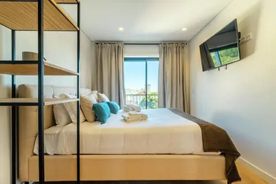 a bedroom with a large bed and a window at Large Terrace in Paraiso III in Porto