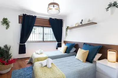 a living room with a couch and a window at Host Wise - Comfy Bright Flats with Netflix in Porto