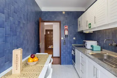 a kitchen with a counter with a bowl of fruit on it at Host Wise - Comfy Bright Flats with Netflix in Porto