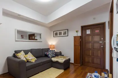 a living room with a couch and a door at Host Wise - Comfy Bright Flats with Netflix in Porto