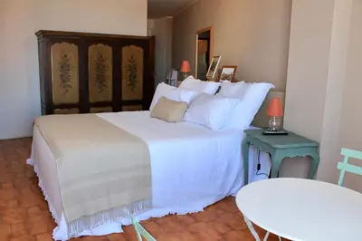 a bedroom with a large bed with white sheets at Jardim do Morro Places in Vila Nova de Gaia