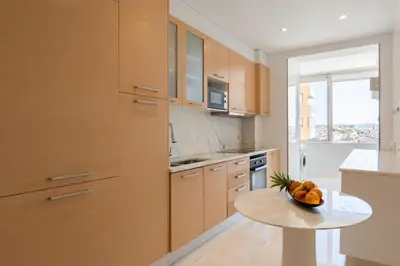 a kitchen with a table with a bowl of fruit on it at Carolina Roomy & Modern Apartment in Porto