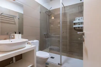 a bathroom with a toilet and a sink and a shower at Host Wise - Impressive Restful Houses in Porto