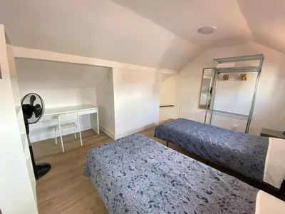 a small bedroom with two beds and a desk at BREINER 54 in Porto