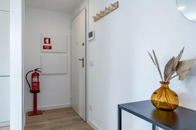 a hallway with a table and a fire hydrant at Nomads Lux - 1BDR Charming Top Floor Porto in Porto