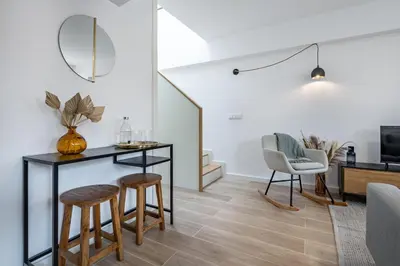 a living room with a desk and two chairs at Nomads Lux - 1BDR Charming Top Floor Porto in Porto