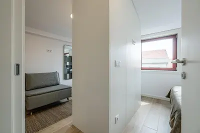 a living room with a chair and a window at Nomads Lux - 1BDR Charming Top Floor Porto in Porto