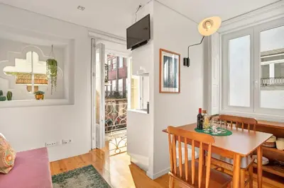 a kitchen and dining room with a table and chairs at Host Wise - Lovely Shinny Flats with Balcony - Clerigos in Porto