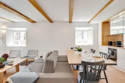 a living room with a couch and a table at Miragaia Apartments by DA'HOME in Porto