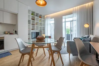 a dining room and living room with a table and chairs at Nomad's Lux - Almada Apartments Porto in Porto