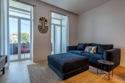 a living room with a blue couch and a table at Nomad's Lux - Almada Apartments Porto in Porto