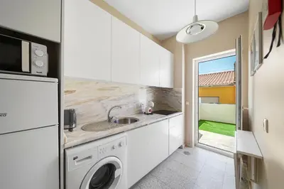 a kitchen with a sink and a washing machine at New Apartments Luiz I Bridge by Amber Star Rent in Vila Nova de Gaia