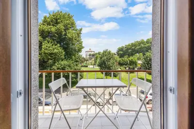 a patio with a table and chairs on a balcony at New Apartments Luiz I Bridge by Amber Star Rent in Vila Nova de Gaia
