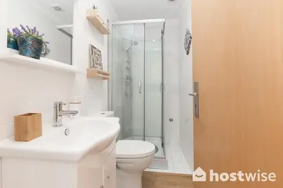 a bathroom with a shower and a toilet and a sink at Host Wise - Colorful Fresh Flats - Batalha in Porto