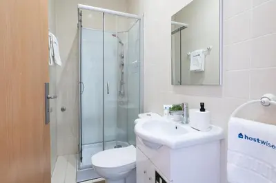 a bathroom with a toilet and a sink and a shower at Host Wise - Colorful Fresh Flats - Batalha in Porto