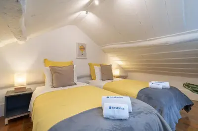 two beds in a room with yellow and blue at Host Wise - Modern Studios with Terrace - Walk Everywhere in Porto