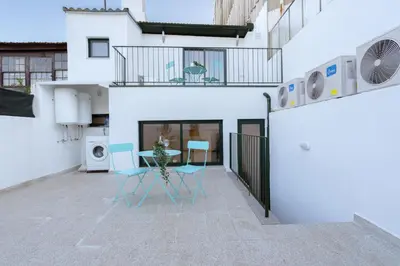 a patio with a table and chairs in a building at Host Wise - Modern Studios with Terrace - Walk Everywhere in Porto