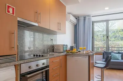 a kitchen with a sink and a counter top at Host Wise - Bright Quiet Flats - Prime Location in Porto
