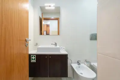 a bathroom with a sink and a mirror at Host Wise - Bright Quiet Flats - Prime Location in Porto