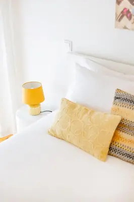 a white bedroom with a bed with a painting on the wall at Oporto Urban Mood in Porto