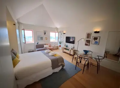 a bedroom with a large bed and a table at Fontainhas Hidden Gem in Porto