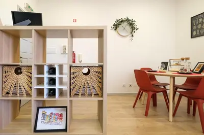 a dining room with a table and a shelf with wine bottles at Dennis Family Friendly House by RDC in Porto