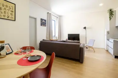 a living room with a table and a couch at Dennis Family Friendly House by RDC in Porto