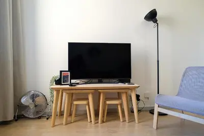 a tv sitting on a table in a living room at Dennis Family Friendly House by RDC in Porto