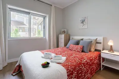 a bedroom with a bed with two plates on it at Host Wise - Modern Flats with Stunning Terrace or Balcony - Central Location in Porto