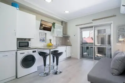 a kitchen with a washer and dryer in a apartment at Host Wise - Modern Flats with Stunning Terrace or Balcony - Central Location in Porto