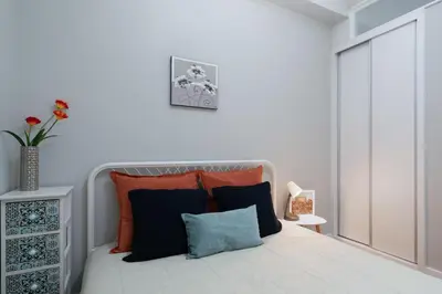 a bedroom with a bed with orange and blue pillows at Host Wise - Modern Flats with Stunning Terrace or Balcony - Central Location in Porto