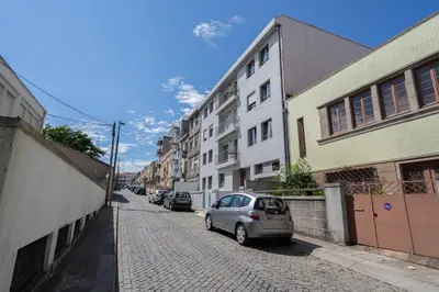a small silver car parked on a cobblestone street at Host Wise - Bright Fresh Flat with Garage - Marquês in Porto