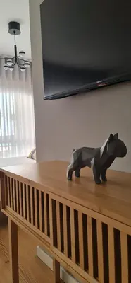 a wooden sculpture of a dog on top of a table at Campanhã Studio in Porto