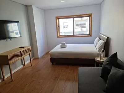 a small room with a bed and a couch at Campanhã Studio in Porto
