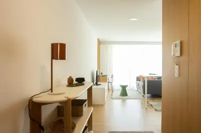 a living room with a table with a lamp on it at My Home is Yours in Porto
