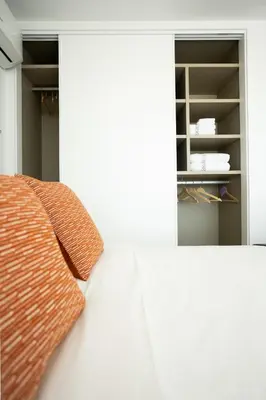 a bedroom with a bed and a book shelf at My Home is Yours in Porto