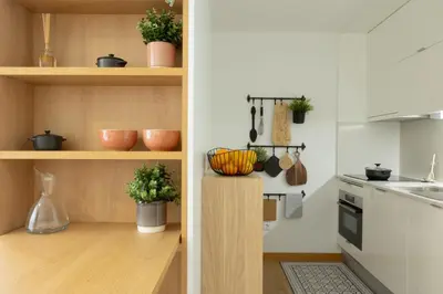 a kitchen with wooden shelves with potted plants at My Home is Yours in Porto