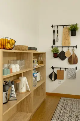 a kitchen with wooden shelves with utensils at My Home is Yours in Porto